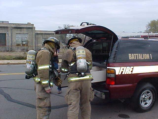 Two fire fighters in full gear plan their next move.